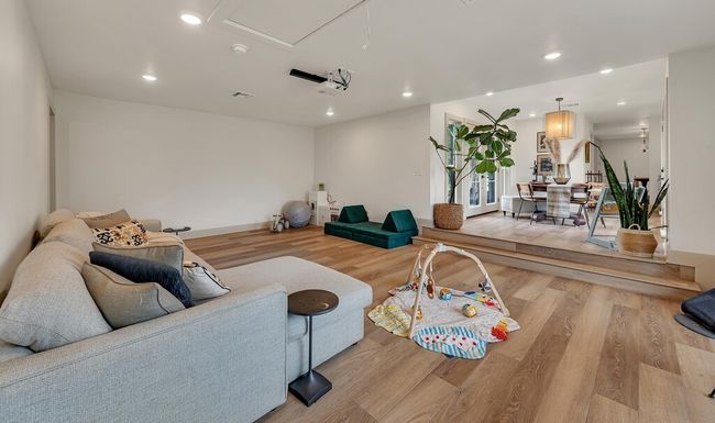 Living area with wood finished floors and recessed lighting | Image 22