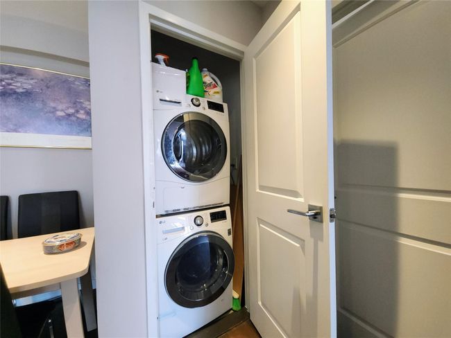 Laundry area featuring laundry area and stacked washer and dryer | Image 5