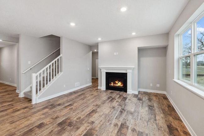 Spacious living room with electric fireplace (not shown). Model photo. Options and colors will vary. | Image 12