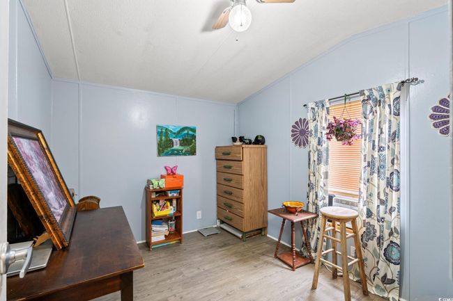Home office with wood finished floors, ceiling fan, and vaulted ceiling | Image 16