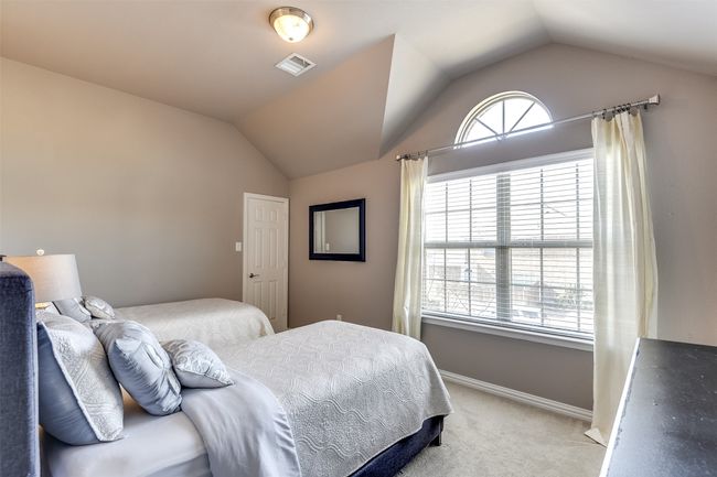 Bedroom featuring light carpet and lofted ceiling | Image 40