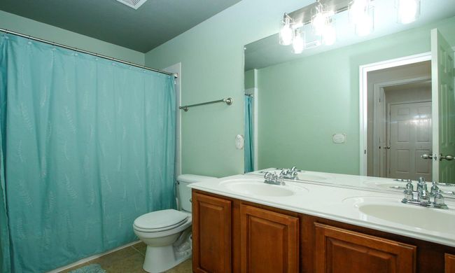 Shared bathroom for 2 secondary bedrooms. His and her sinks and a tub/shower combo. | Image 15