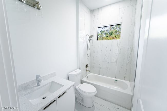 Full bathroom featuring vanity, toilet, and shower / bath combination | Image 17
