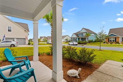 Rocking chair front porch with a view of the street | Image 3