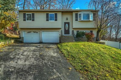 Split foyer home with a garage and a front yard | Image 1