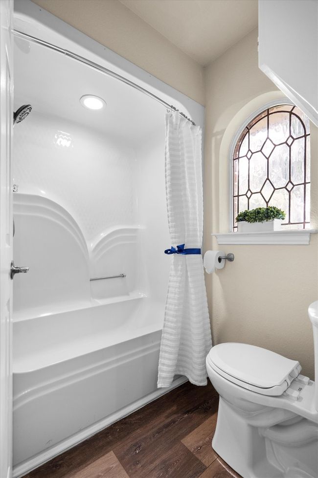 The tub and commode have a door for privacy from the vanity area. | Image 25