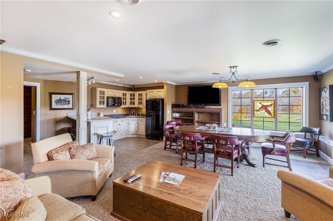 Living area with decorative columns, ornamental molding, light colored carpet, and recessed lighting | Image 41