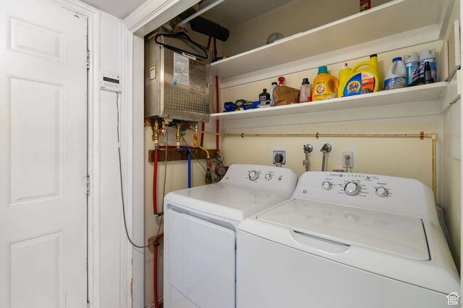 Washroom featuring water heater, separate washer and dryer, and laundry area | Image 10