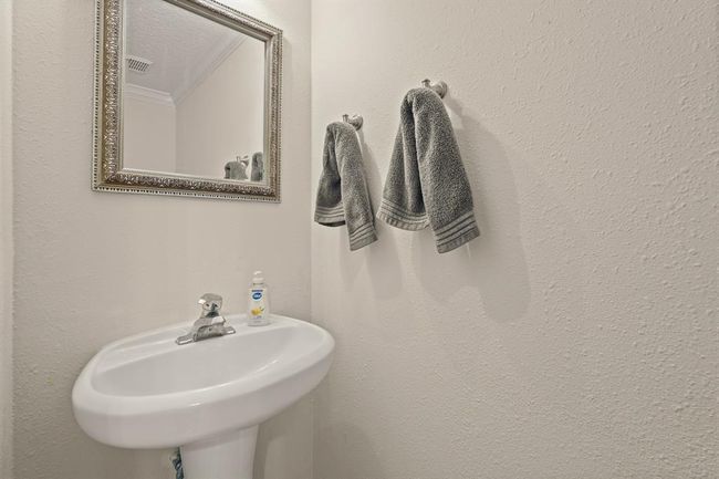 Conveniently located downstairs, this stylish half bath offers practicality and charm. | Image 14