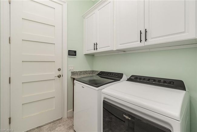 Laundry room with cabinets and separate washer and dryer | Image 14