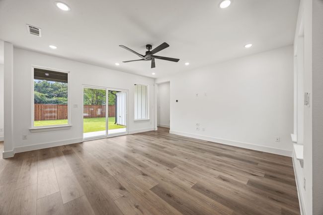 Empty room featuring a ceiling fan, wood finished floors, recessed lighting, and baseboards | Image 13