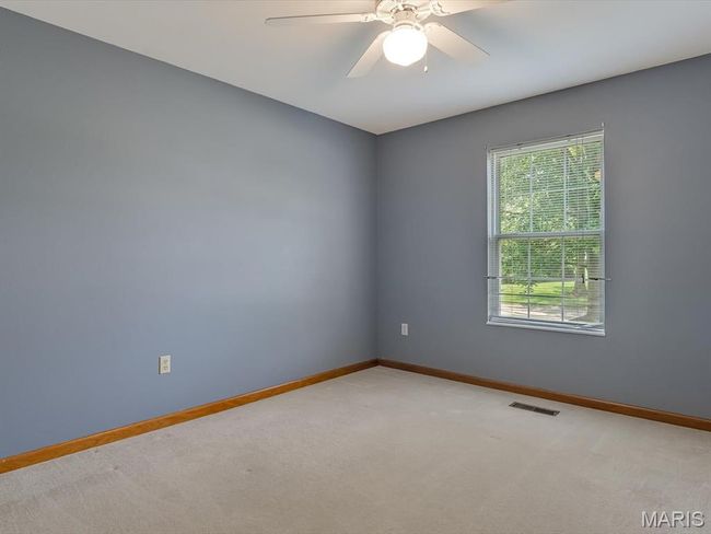 Bedroom featuring light carpet and a ceiling fan | Image 19