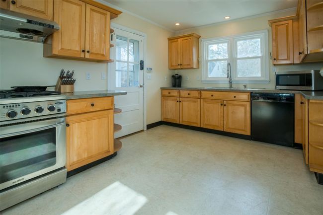 Kitchen with range hood, sink, appliances with stainless steel finishes, and ornamental molding | Image 10