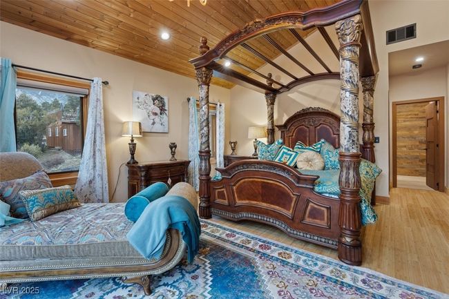 Bedroom featuring lofted ceiling, recessed lighting, wood finished floors, visible vents, and wood ceiling | Image 57
