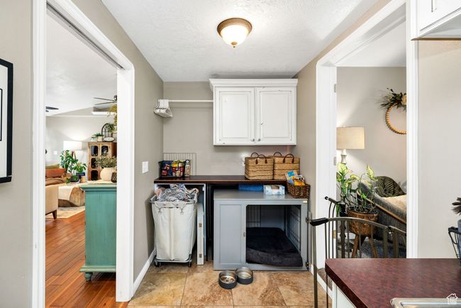 Bar with a ceiling fan and baseboards | Image 12