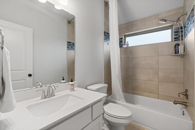 This full bathroom includes a window, tile flooring, and a bathtub/shower combo. | Image 30