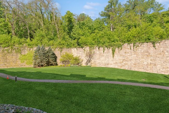 Peace and serenity abound in the expansive green space to the west, offering a tranquil backdrop to your home. | Image 11