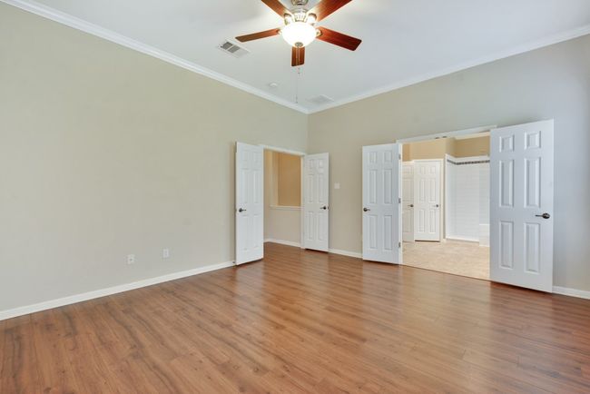 The spacious primary suite is a true retreat, complete with a luxurious bath featuring dual vanities, a walk-in shower, a soaking tub, and an oversized walk-in closet. | Image 22