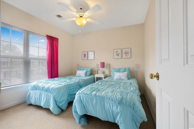Bedroom with baseboards, carpet, and ceiling fan | Image 28