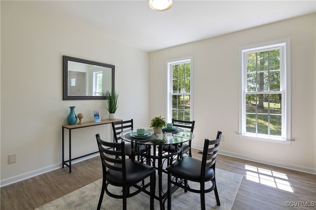 Dining area featuring baseboards and wood finished floors | Image 14