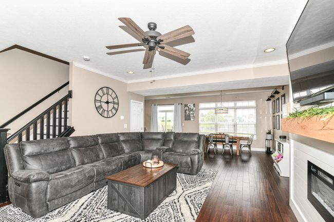 living room featuring ceiling fan, dark wood-style floors, recessed lighting, stairway, and baseboards | Image 8