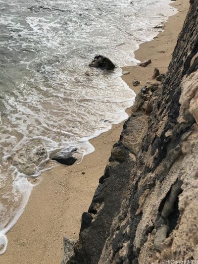 Looking straight down over the sea wall at the waves on your property. Sandy Beach is seasonal. | Image 2