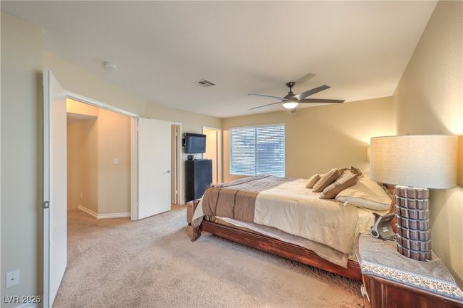 Bedroom featuring light colored carpet and ceiling fan | Image 19