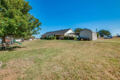 View of yard with a carport and a playground | Image 3