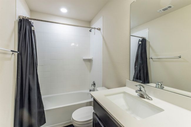 Full bathroom featuring visible vents, vanity, shower / bath combination with curtain, toilet, and recessed lighting | Image 29