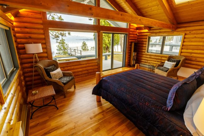 Bedroom featuring log walls, wood-type flooring, wood ceiling, and lofted ceiling with beams | Image 43
