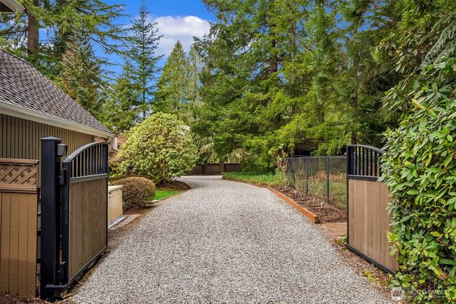 Back gate entrance to arena, stalls, RV & trailer parking as well as hay storage. Easy hauling. | Image 15