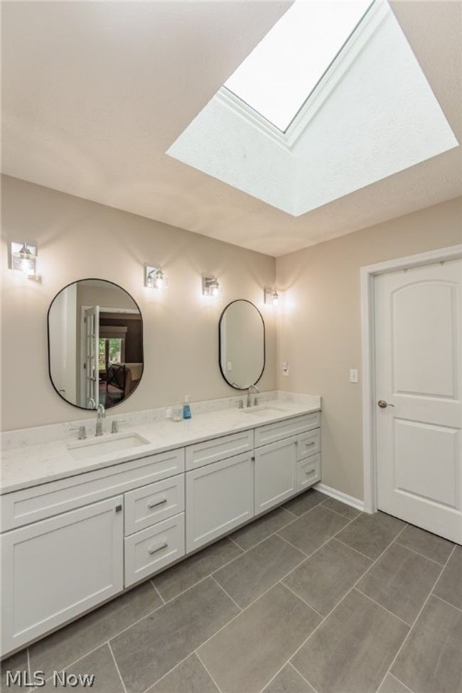 Bathroom with tile floors, a skylight, and dual bowl vanity | Image 27