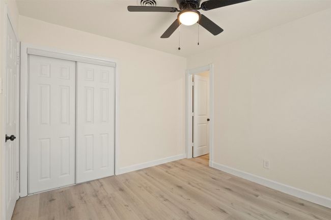 Unfurnished living room with a ceiling fan, baseboards, recessed lighting, light wood-type flooring, and arched walkways | Image 15