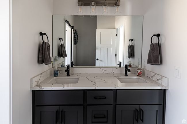 Full bathroom with double vanity and a sink | Image 25