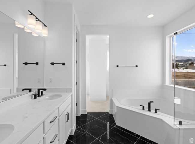 Primary Full bath featuring double vanity, a sink, recessed lighting, and a bath | Image 8