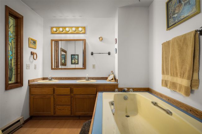 Full bath with wood finished floors, a bath, and double vanity | Image 16