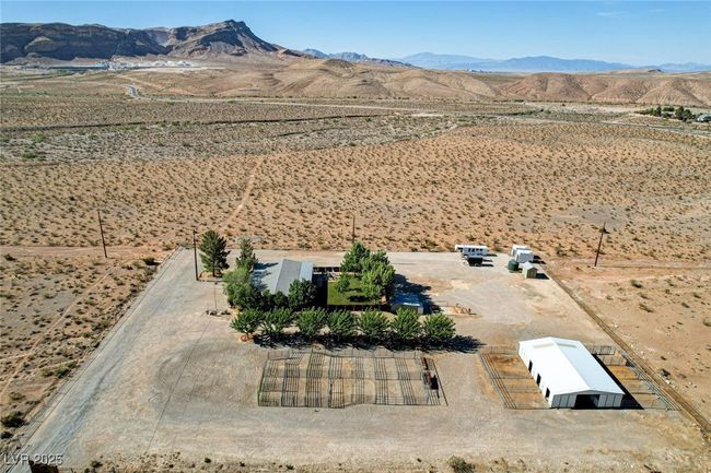 Aerial view of sparsely populated area with mountains and a desert landscape | Image 58