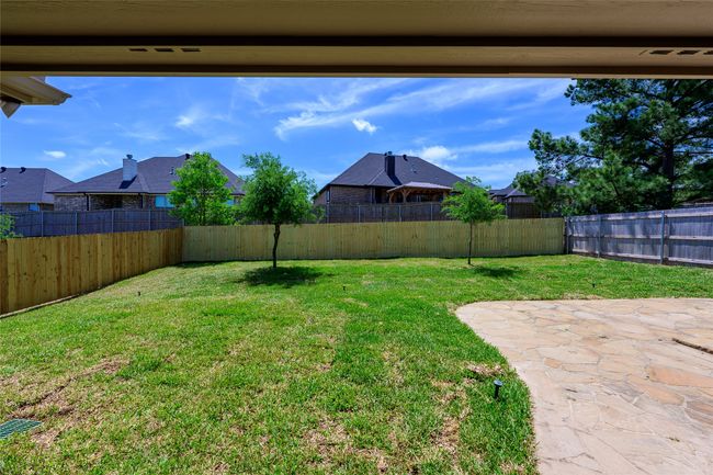 View of yard with a fenced backyard and a patio | Image 26