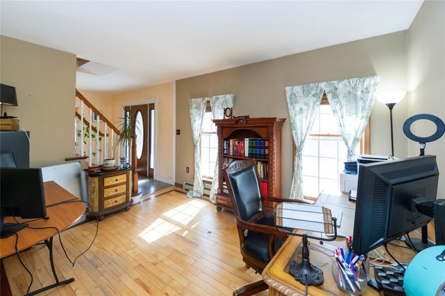 Office featuring a wealth of natural light and light wood-style flooring | Image 27