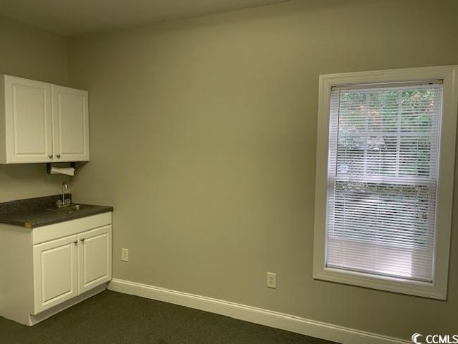 Unfurnished dining area featuring baseboards and a sink | Image 5