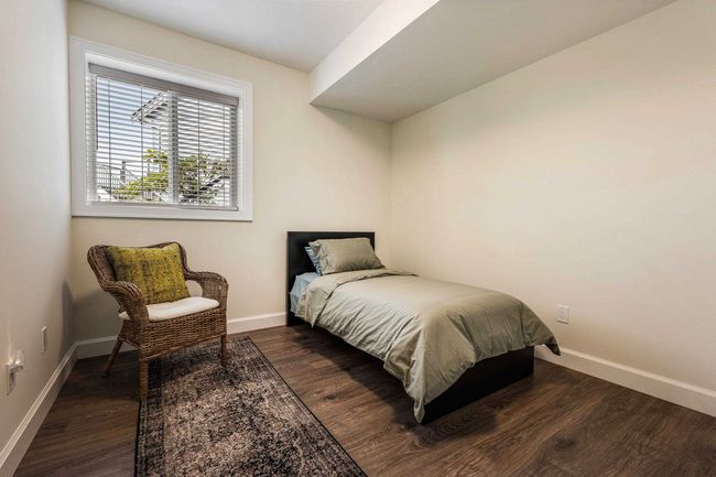 Bedroom with baseboards and wood finished floors | Image 34