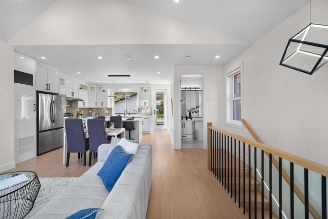 Living area featuring light wood finished floors, lofted ceiling, and recessed lighting | Image 28