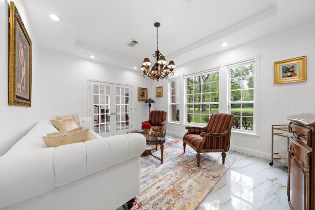 Charming sitting area with large windows and bright walls | Image 19