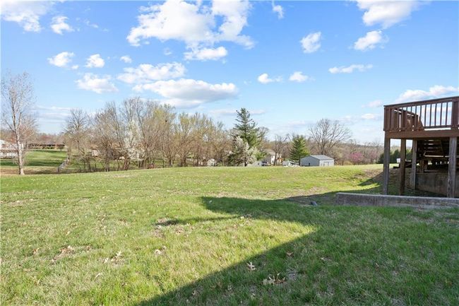 View of yard with a storage unit, a deck, and an outdoor structure | Image 27