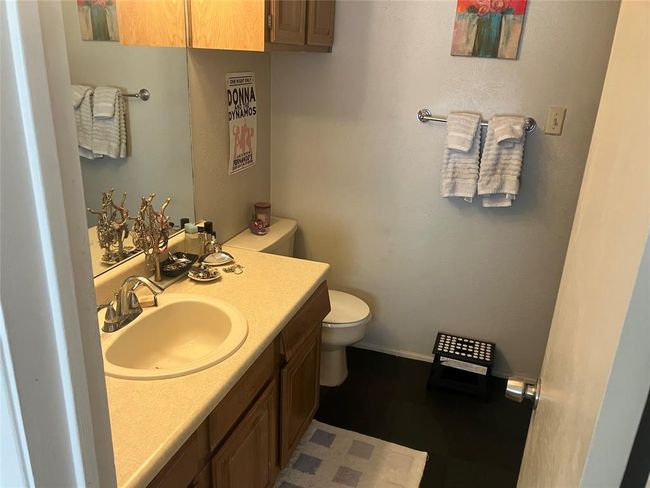 Bathroom with toilet, vanity, and baseboards | Image 12