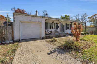 Single story home featuring a porch and a garage | Image 2