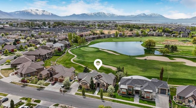 Aerial south facing view featuring the lake on the 18th hole and mountain views. | Image 35