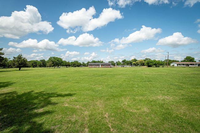 View of green lawn with a view of rural / pastoral area | Image 5