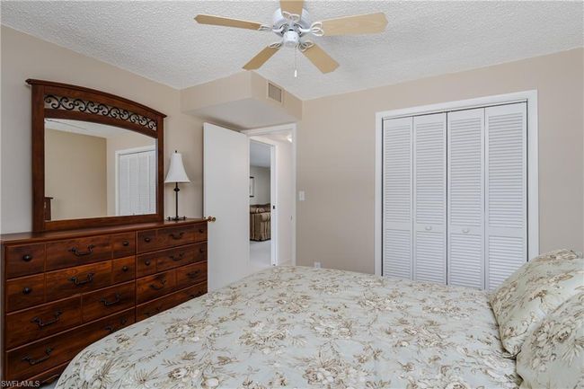 Bedroom with a textured ceiling, a closet, and ceiling fan | Image 20