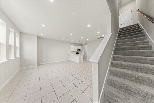 Stairway with tile patterned flooring, baseboards, and recessed lighting | Image 4